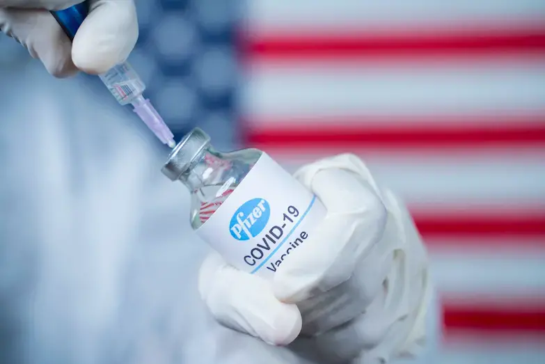 Doctor holding a Pfizer/Biontech vaccine. Image by lakshmiprasada S / Shutterstock. 2020. Doctor holding a Pfizer/Biontech vaccine. Image by lakshmiprasada S / Shutterstock. 2020.