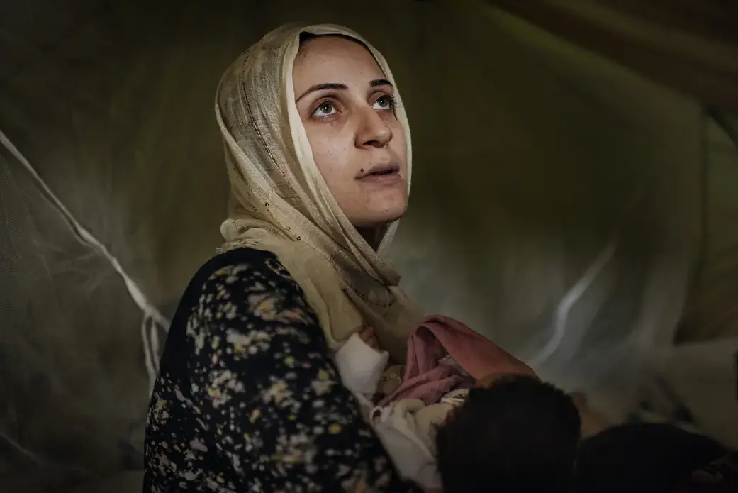 Taimaa Abazli, 24, holds her new baby Heln in their tent at the Karamalis camp in Thessaloniki. Image by Lynsey Addario for TIME. Greece, 2016. Taimaa Abazli, 24, holds her new baby Heln in their tent at the Karamalis camp in Thessaloniki. Image by Lynsey Addario for TIME. Greece, 2016.