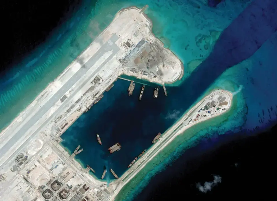 Fiery Cross Reef, an artificial island built by China, boasts a two-mile long runway, massive harbor, and elaborate military fortifications. Image courtesy of CSIS ASIA MARITIME TRANSPARENCY INITIATIVE/DIGITALGLOBE. China, 2018. Fiery Cross Reef, an artificial island built by China, boasts a two-mile long runway, massive harbor, and elaborate military fortifications. Image courtesy of CSIS ASIA MARITIME TRANSPARENCY INITIATIVE/DIGITALGLOBE. China, 2018.