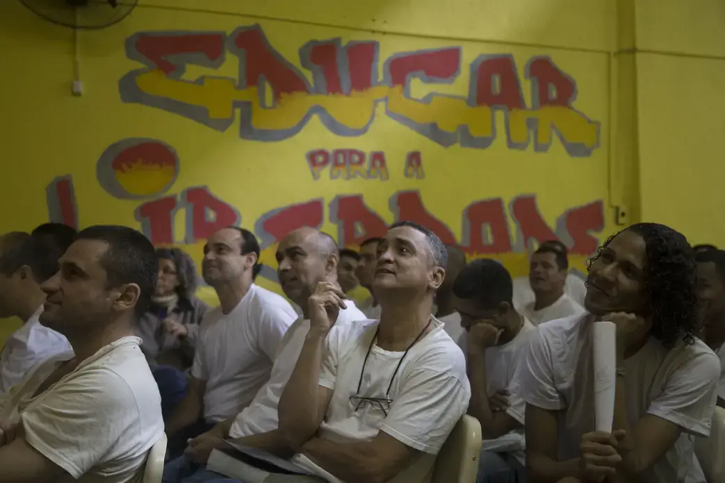 Men in the Evarisio se Moraes watch a theater performance during one of the fine arts workshops. Image by Levi Stroud. Brazil, 2016. Media file: prison1.jpg
