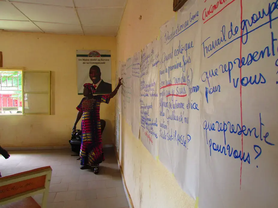 Virginie Moukoro, President of Association pour la Promotion des Droits et du Bien Être de la Femme, conducts a training to challenge gender roles and debunk stereotypes about men and women in Malian society to local leaders in Ouelessebougou. Image by Kateri Donahoe. Mali, 2015. Media file: img_1049.jpg