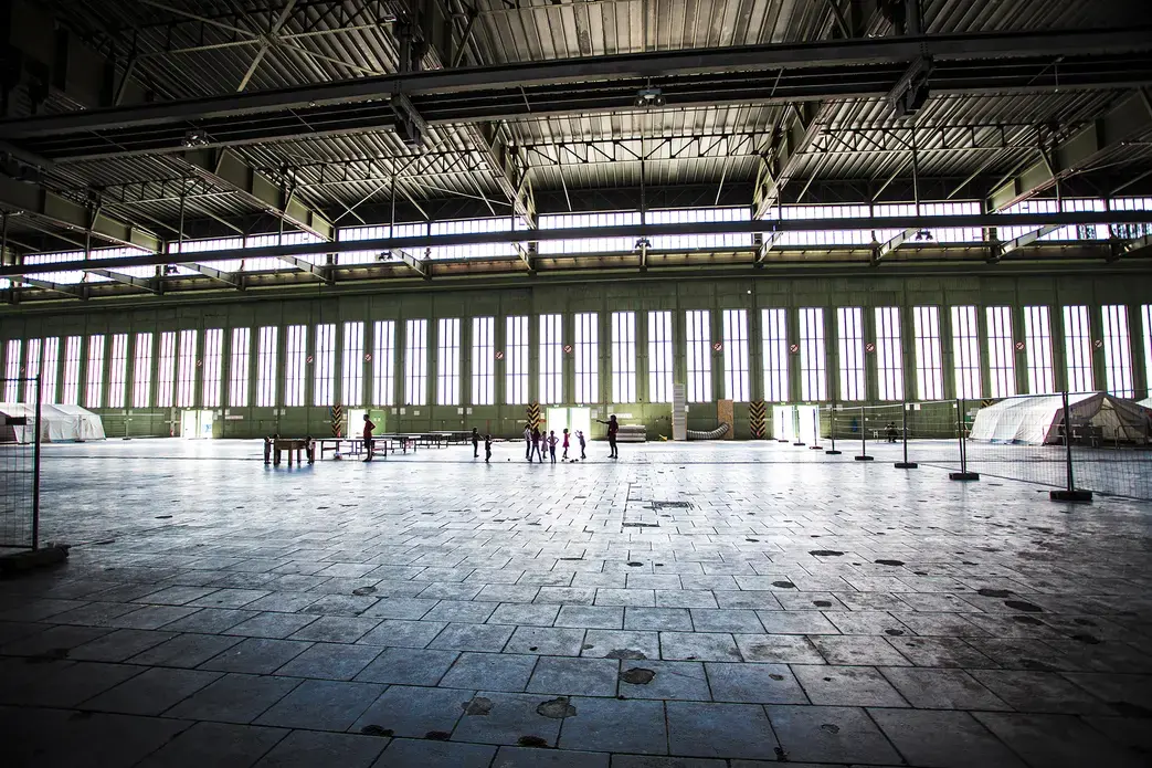 Children play in a hanger in Tempelhof airport, once a Nazi hanger and now home to over 2000 refugees. Image by Emily Kassie. Germany, 2016. Children play in a hanger in Tempelhof airport, once a Nazi hanger and now home to over 2000 refugees. Image by Emily Kassie. Germany, 2016.