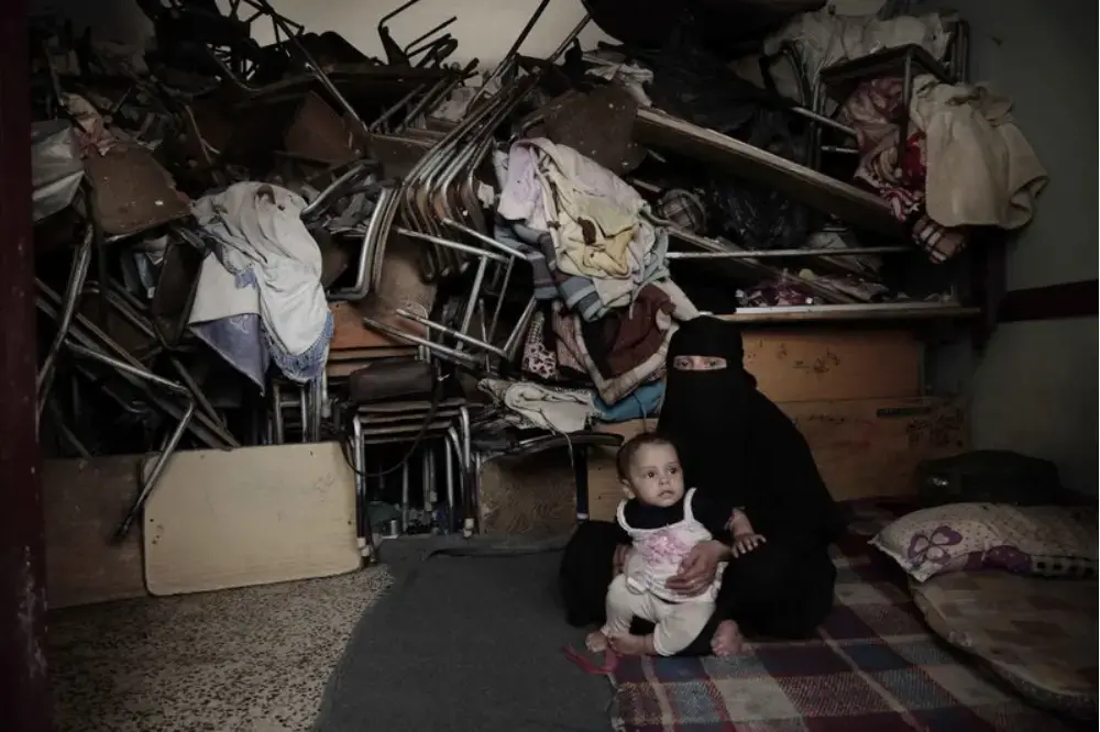 A woman sits with her baby inside a shelter for displaced persons in Ibb. Image by Nariman El-Mofty/AP Photo. Yemen, 2018. A woman sits with her baby inside a shelter for displaced persons in Ibb. Image by Nariman El-Mofty/AP Photo. Yemen, 2018.