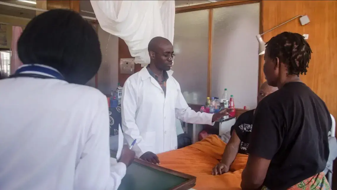 Stanley Zimba examines a patient. Image courtesy of DMS Productions/Dawson Sikute. Zambia, 2019. Stanley Zimba examines a patient. Image courtesy of DMS Productions/Dawson Sikute. Zambia, 2019.
