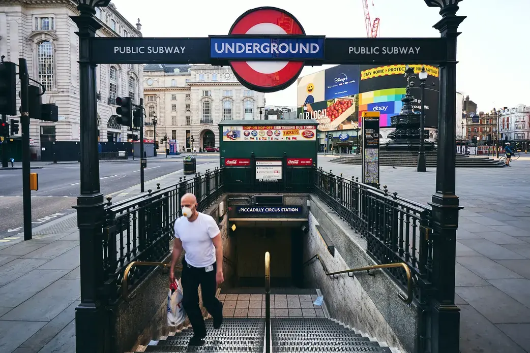 A person wearing a mask exits the London underground. Photo by Matteo Roma / Shutterstock. United Kingdom, 2020. A person wearing a mask exits the London underground. Photo by Matteo Roma / Shutterstock. United Kingdom, 2020.