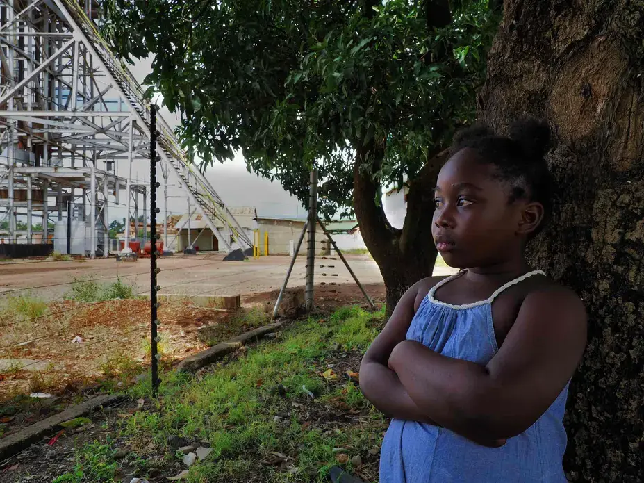 Lead poisoning victim Royce Sakaloa, 6, plays in her backyard less than 50m from the entrance to the former mine. Image by Larry C. Price. Zambia, 2017.