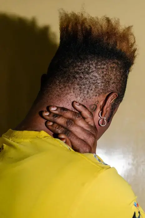 Chupet, 22, a transgender woman and refugee from the Democratic Republic of the Congo, poses for a portrait in Kampala. Since arriving in Uganda in 2013, she says she has been unable to acquire legal refugee status because of obvious identity as a trans woman. Image by Jake Naughton. Uganda, 2017.