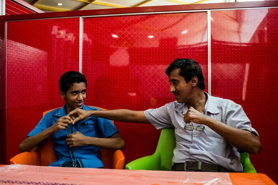 Hamza and Fathi wait for their food during lunch in Aden. Image by Alex Potter. Yemen, 2018.