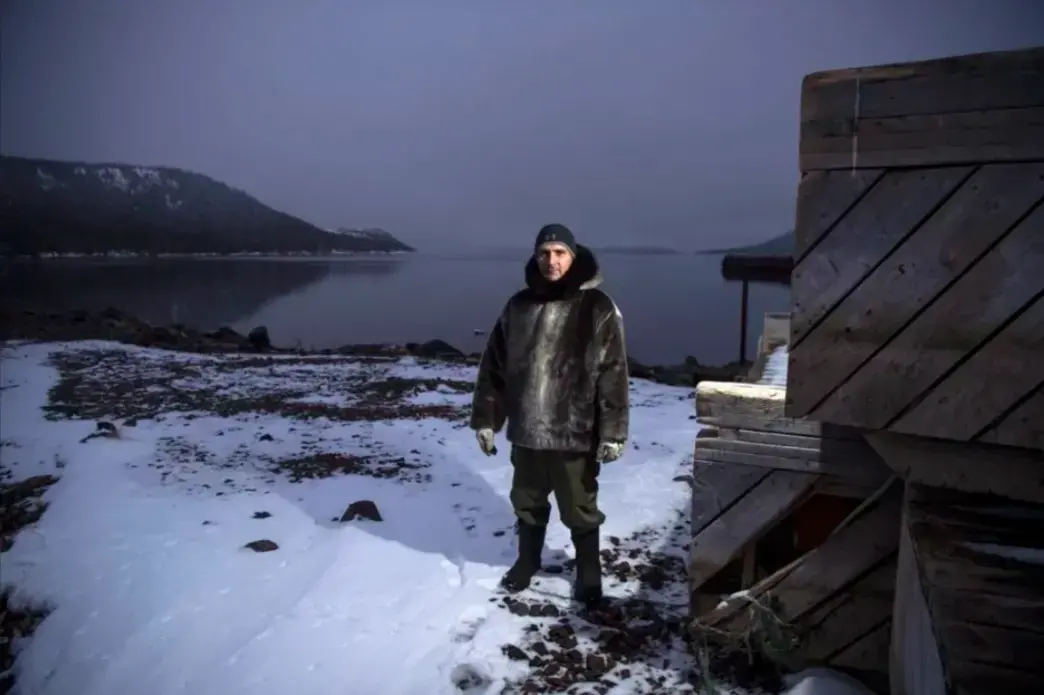 Karl Michelin poses for a portrait at the water's edge of Lake Melville in Rigolet wearing a dickie made of seal skin from a seal he hunted from the bay on Nov. 13, 2019. Image by Michael G. Seamans. Canada, 2019.<br />
