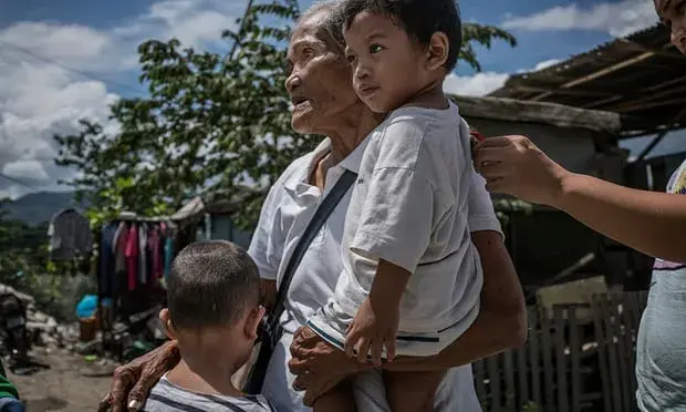 Remy Fernandez’s son, a methamphetamine user, was shot. She has been left to raise seven grandchildren. Image by James Whitlow Delano. Philippines, 2018. 