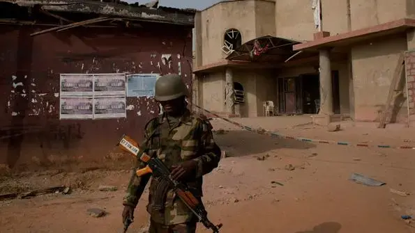 A soldier walks away from a church attacked by Boko Haram. Image by Bénédicte Kurzen. Nigeria, 2012. Media file: 20120114_SSP507_1_0.jpg