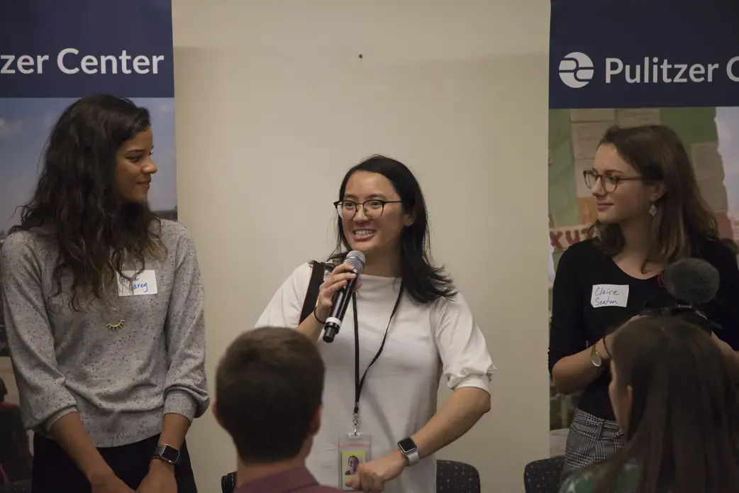 Pulitzer Center intern Karena Phan with speaking to student fellows during staff introductions. Behind her is Pulitzer Center staff member Hana Carey and intern Claire Seaton. Image by Jin Ding. United States, 2018. 