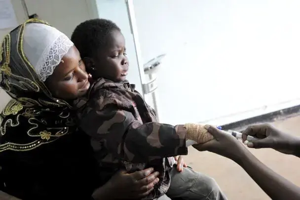 Swabura Namiiro, 4, receives care at the Uganda Cancer Institute in Kampala. Her family discovered the institute had many patients with leukemia. "This gave us a sense of support and gave us some strength," Swabura's mother says. Image by Jacqueline Koch. Uganda, 2012. Media file: 2019906472.jpg
