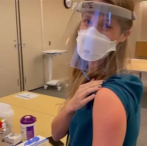 Kate smiles after receiving the first dose of the Pfizer-BioNTech COVID-19 vaccine in December. Image courtesy of Kate. United States, 2020.