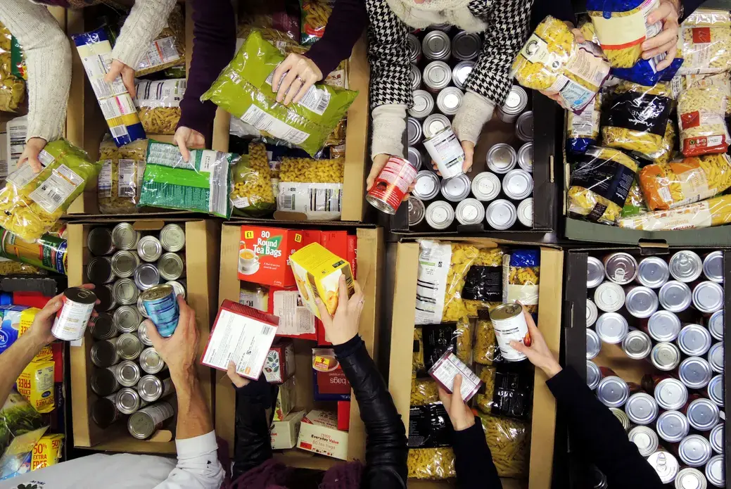 Trussell Trust volunteers sort through food. Image courtesy of Trussell Trust. United Kingdom, undated.