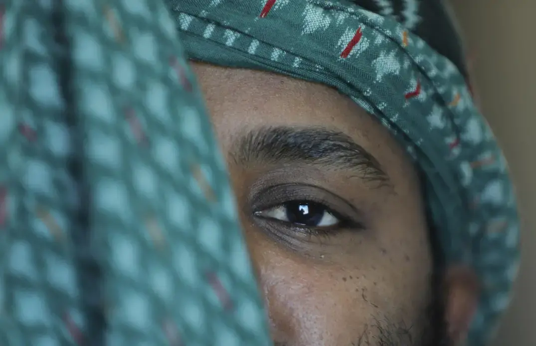 A close-up portrait of a man, with a focus on his eye.