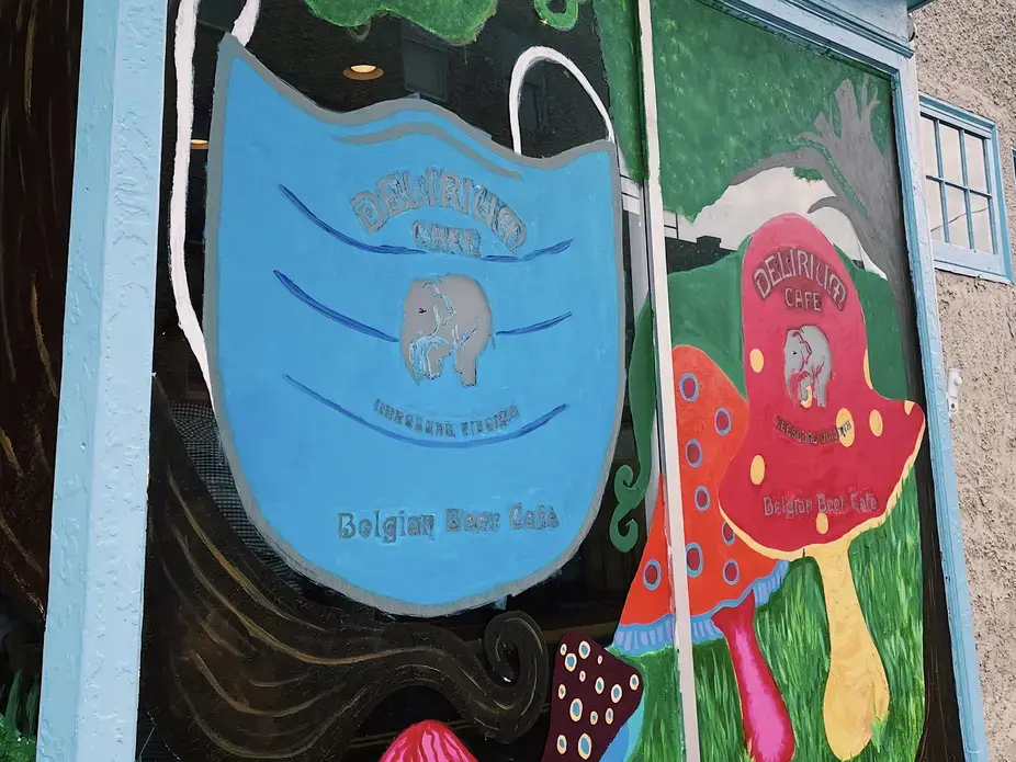 A mural on a wall featuring a medical mask and mushrooms.