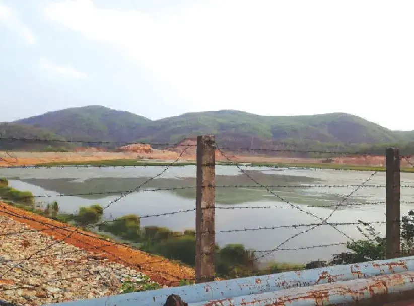 43-1.jpeg Image of a pond behind a fence.