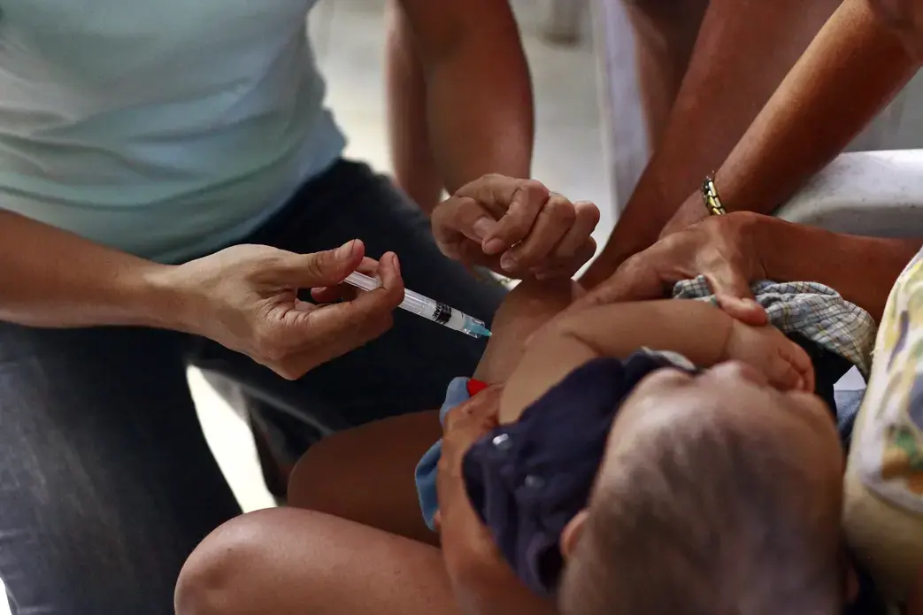 6358613209_736b2f96d0_k.jpg Health worker injecting vaccine to child.