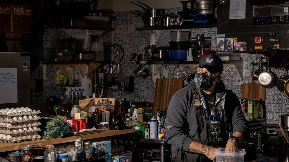 A masked chef in his kitchen