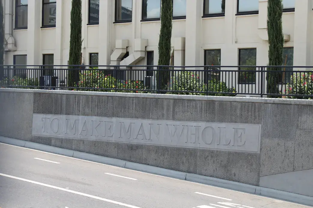 Sign reads "to make man whole"