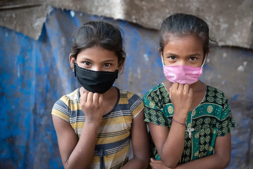 shutterstock_1717165501.jpg Masked children in Mumbai India.