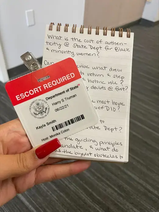 notebook and badge in hand