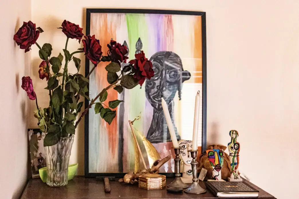 roses and artwork on table