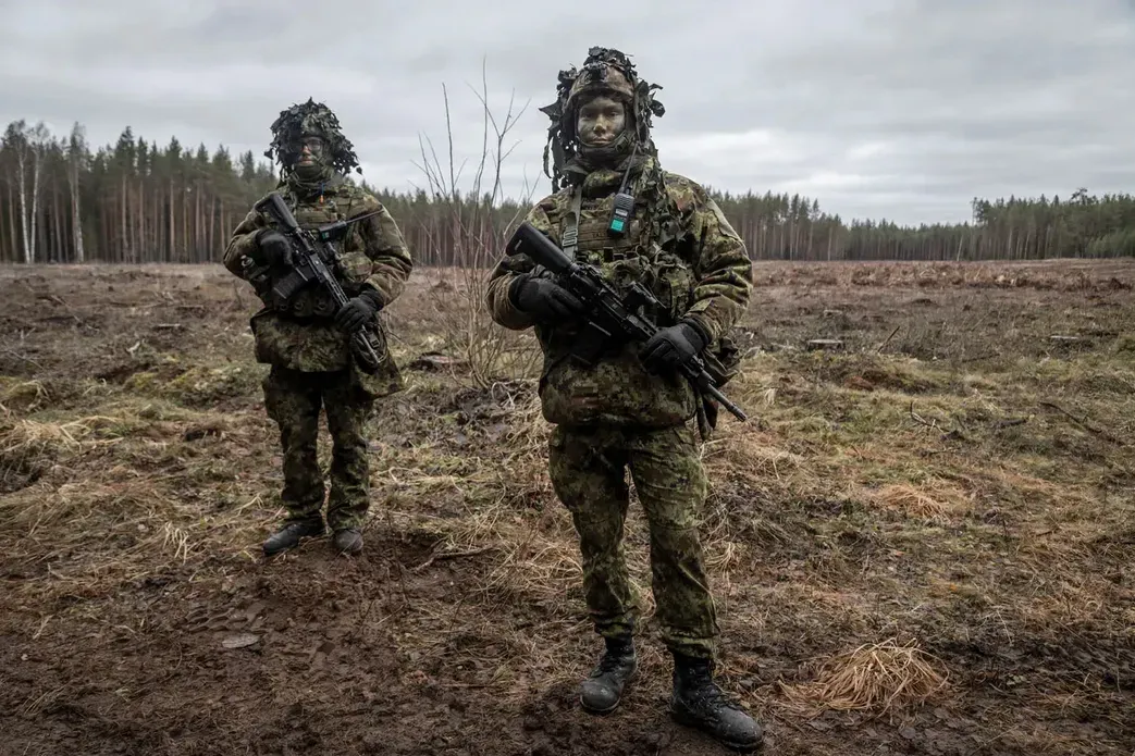 Two young soldiers armed, in uniform with painted faces pose for a picture