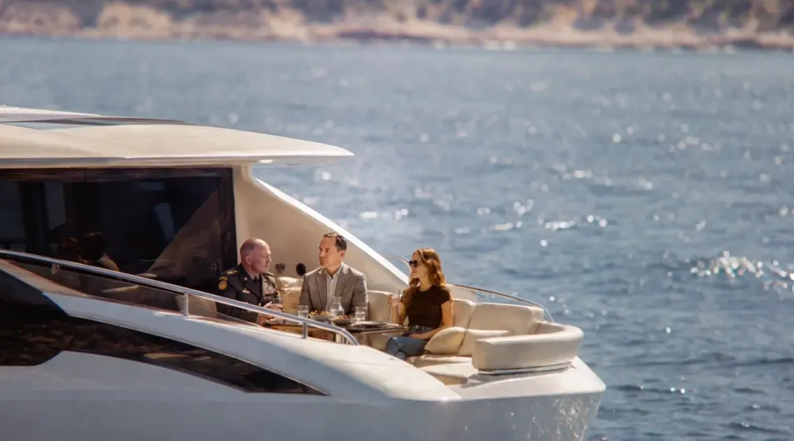AI Image: a man and a woman sit on the back of a yacht in the water with another man in a general's uniform