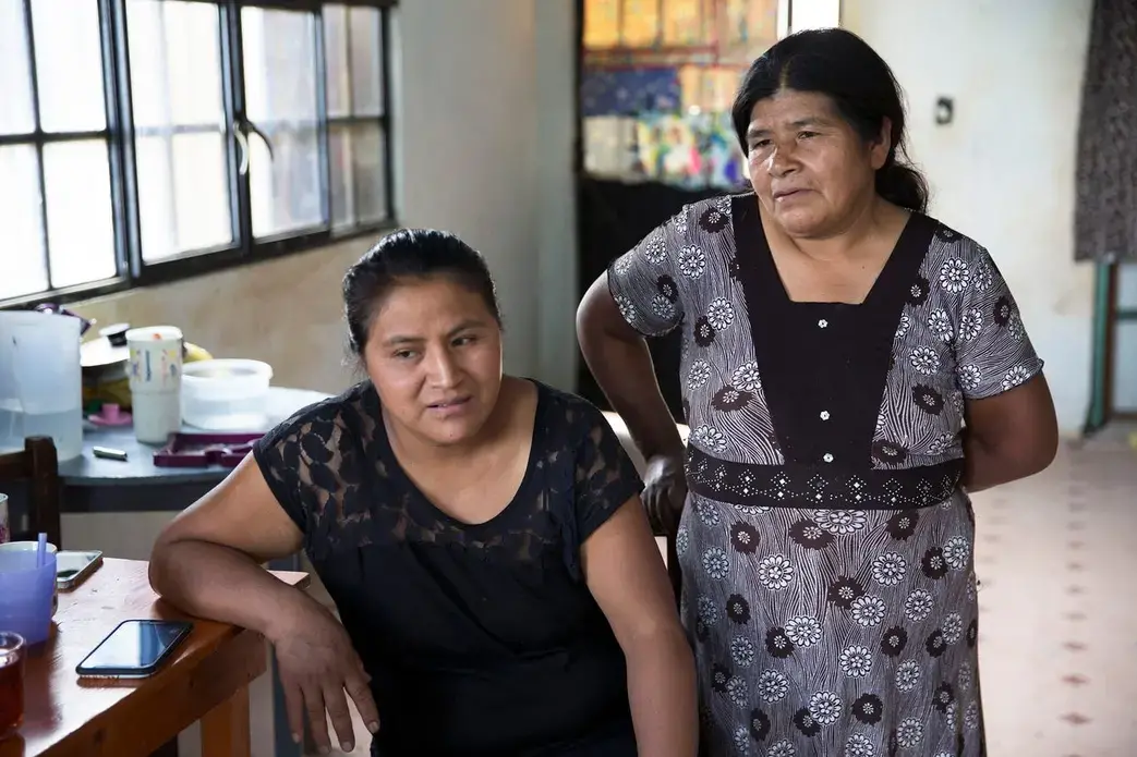 Roberto Tecpile's wife, Verónica Montalvo, and his mother, Concepciona Acahua, in the home that Tecpile's family is building in Astacinga, México, thanks to his work at a Wisconsin dairy farm. Image by Rick Barrett. Mexico, 2019.
