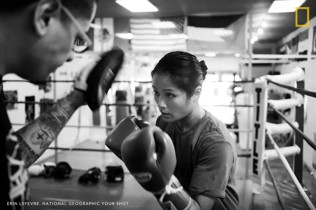 Casey Morton spars with her full-time coach Jairo Escobar at the World Class Boxing Gym in San Francisco. This is from my series ‘Fights Like a Woman which documents Hawaiian boxer Casey Morton’s journey to becoming a professional athlete in a male-dominated sport. Image by Erin Lefevre. United States.
