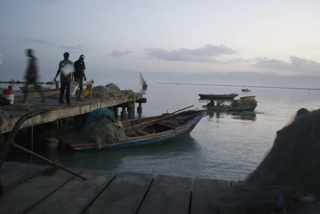 Fisherman in Cite Soleil prepare to fish early on a sunday morning. For them, daily obligations are more pressing than thoughts about cholera - the now endemic disease that still takes lives in their country. Image by Jason Hayes. Haiti, 2012. Media file: 2.jpg