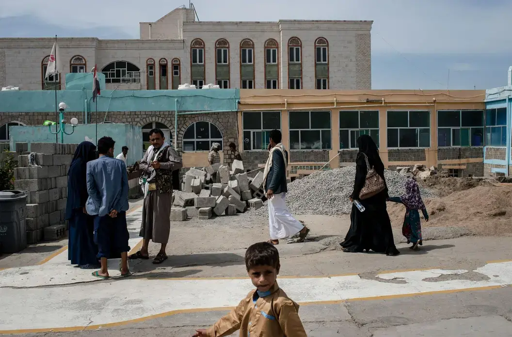 Mohammad walks through the grounds of Jumhuri Hospital, where he and his father went in search of surgical care for Mohammad's fistula. Image by Alex Potter. Yemen, 2018.