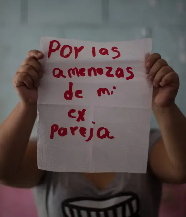 María, 22.</p>
<p>The napkin reads: 'because of the threats by my ex-boyfriend.' She lives in fear of her ex-partner, an MS-13 gang member whose violence led her to a suicide attempt at age 15. From time to time, she thinks of killing herself when she realizes that she must face life on her own and without the support of her partner, who was killed by members of the other gang, Barrio 18. She currently resides in the United States, where she is requesting asylum. Although she says she feels peace, she is still afraid.</p>
<p>Image by Almudena Toral. El Salvador, 2018.