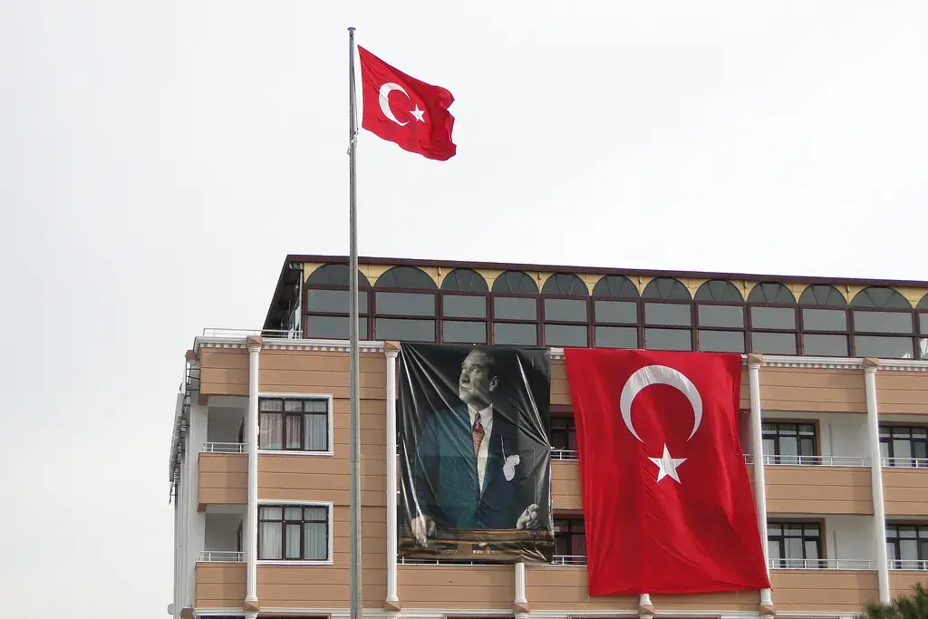 Kemal Atatürk's banner hangs along side Turkish flags from the facade of a building in Eceabat, Dardanelles, Turkey. Atatürk was a revolutionary Ottoman and Turkish army officer who founded Republic of Turkey as a modern, westernized and secular state — the principles known as Kemalism. Image by Adam Jones. Turkey, 2011. Media file: 5734233427_beb227df63_b.jpg