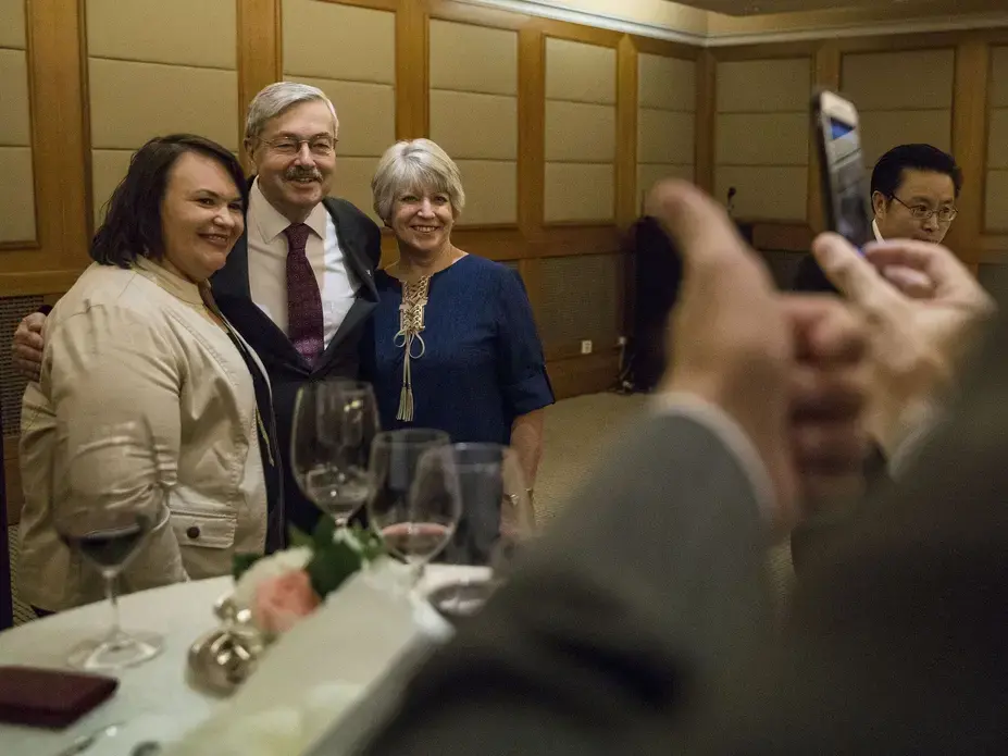 Kim Heidemann, executive director, of Iowa Sister States poses for a photo with Terry Branstad, U.S. ambassador to China and his wife Chris Branstad during an Iowa Sister States reception on Wednesday, Sept. 20, 2017, in Beijing, China. Image by Kelsey Kremer. China, 2017.