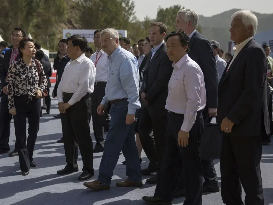 Hebei Party Secretary, Zhafo Kezhi, US Ambassador to China, Terry Branstad, Vice Minister of Agriculture‎, Qu Donyu, and farmers from Iowa, Grant and Rick Kimberley, walk together through the groundbreaking ceremony for the China-US Demonstration Farm on Saturday, Sept. 23, 2017, in Luanping County, Hebei, China. Image by Kelsey Kremer.