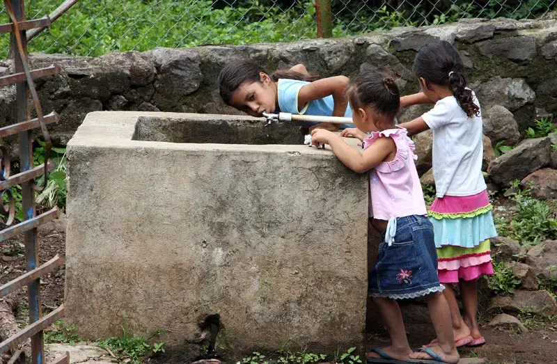 Three young girls from the rural village of El Carmen drink water straight from the water well, after consulting with the doctor about various ailments. Image by Tracy Boyer. Honduras, 2009. Media file: 6a00d834520a2e69e201157189878c970b-800wi.jpg
