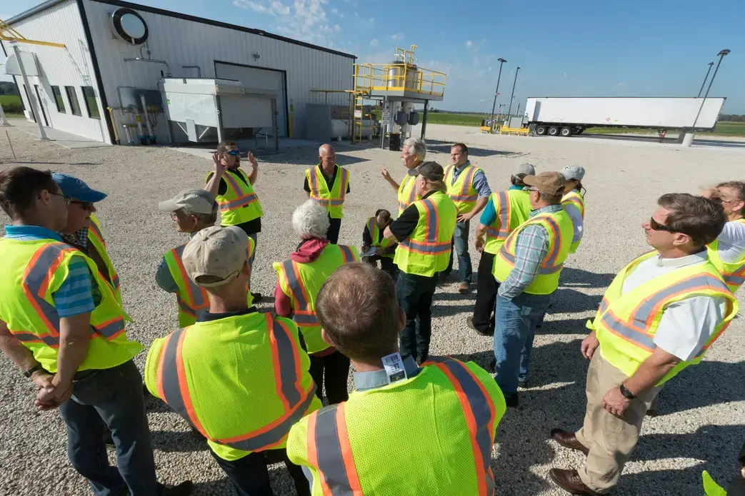 J.J. Pagel, (hands in the air) of Pagel's Ponderosa, a dairy farm, shows members of the Wisconsin Natural Resources Board a system that converts manure into methane gas. Image by Mark Hoffman. United States, 2019.