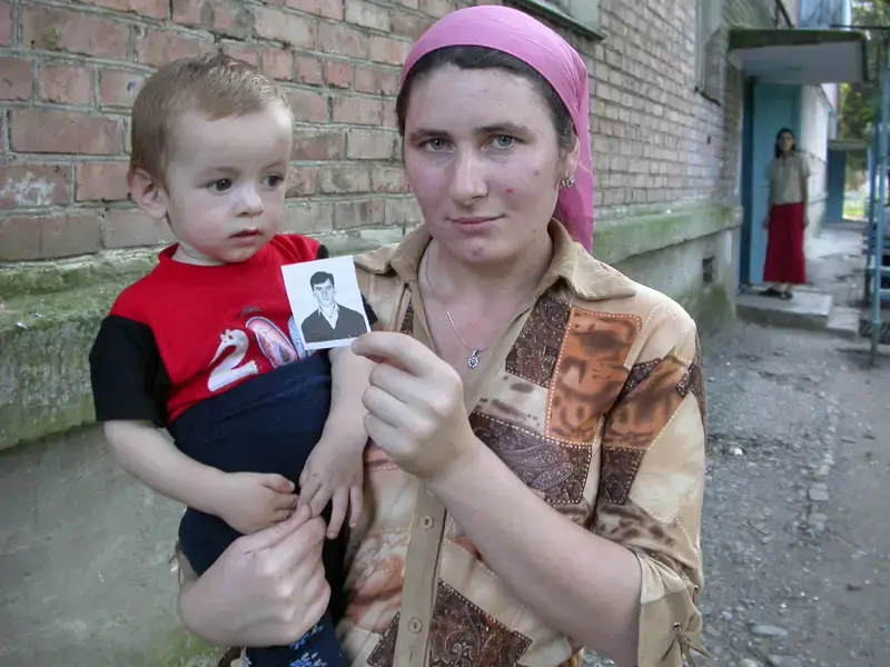 A woman in Sernovodsk, Chechnya, holds a picture of her brother, allegedly killed by Russian security forces in 2004. Image by Tom Parfitt, Chechnya, 2004. A woman in Sernovodsk, Chechnya, holds a picture of her brother, allegedly killed by Russian security forces in 2004. Image by Tom Parfitt, Chechnya, 2004.