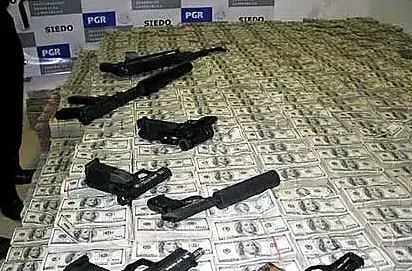 $205 million drug money seized by the Mexican Police and the Drug Enforcement Administration in Mexico city — largest single drug cash seizure in history. Image by Drug Enforcement Administration. Mexico, 2007. Media file: Drug_Money_and_weapons_seized_by_the_Mexican_Police_and_the_DEA_2007.jpg