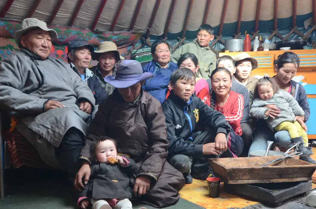 Nomadic herder Hurelchuluun (far left), his wife (center rear, in blue) and some of their extended family. Image by Daniel Grossman. Mongolia, 2011. image