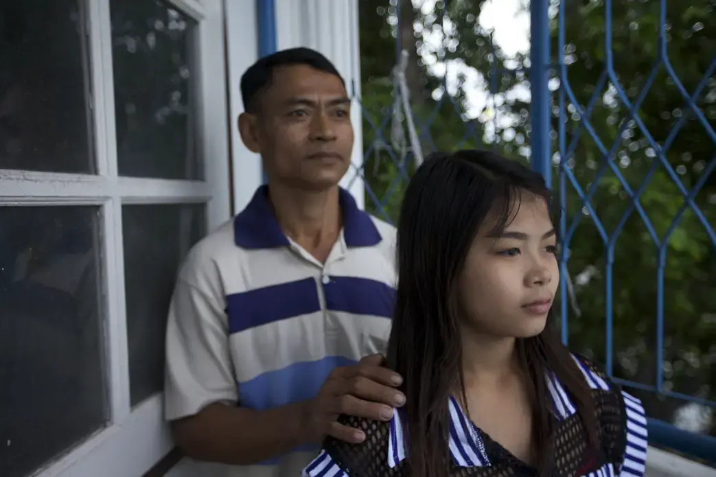 Thazin Mon and her father in Samut Sakhon province in Thailand. To help support her Burmese migrant family, the 14-year-old worked in a small peeling shed where she was beaten and forced to pull 16-hour shifts, seven days a week, for less than $3 a day. Image by Jason Motlagh. Thailand, 2012. Media file: IMG_7370.jpg