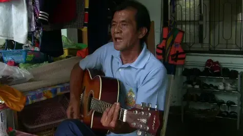 Kriengsak Sathienwatana (Toy) plays music by the Scorpions, and discusses the elections. Image by Jesse Hardman. Thailand, 2011. image