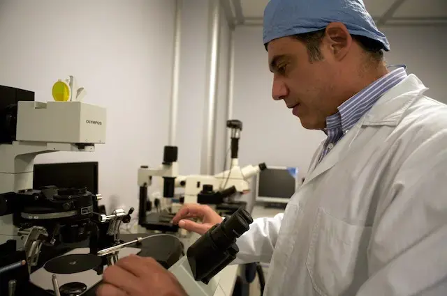 Savvas Koundouros looks through a microscope at the Genesis clinic in Limassol, Cyprus.