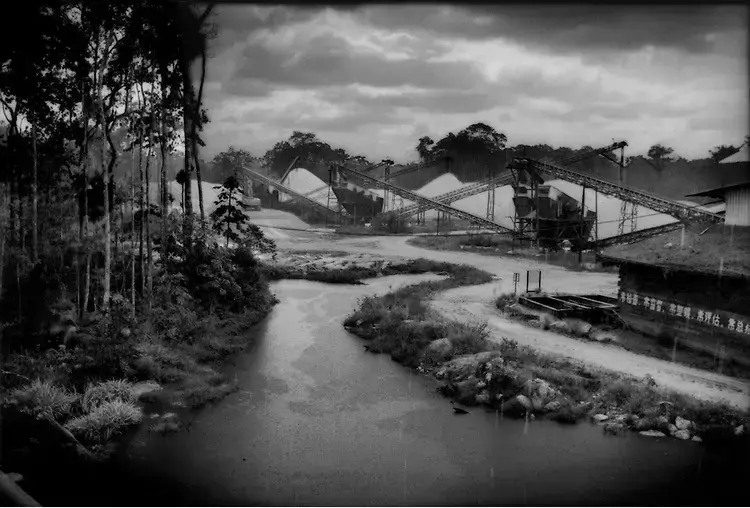 Rainforest crowds the perimeter of a gravel quarry run by China Dalian International. Image by James Whitlow Delano. Suriname, 2012. Media file: Screen Shot 2013-01-28 at 12.34.15 PM.jpg