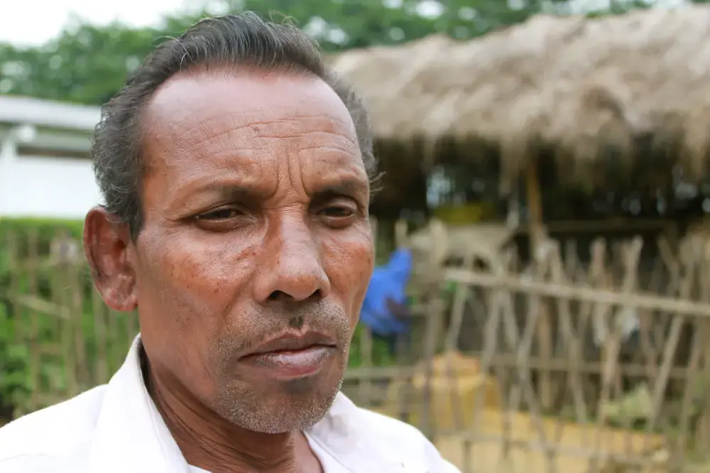 Bhangru's father, Rama Lohar, sits outside his home. His family has lived and worked in this tea plantation for generations. Media file: Tea.Father.jpg