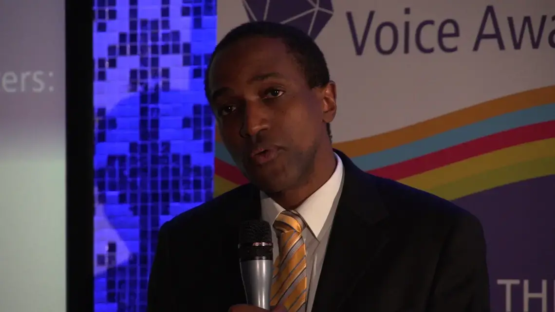 Maurice Tomlinson accepting the inaugural David Kato Vision and Voice Award, which recognizes individuals who strive to uphold the rights of lesbian, gay, bisexual, transgender and intersex (LGBTI) people around the world. Media file: Tomlinson at Kato Award.png