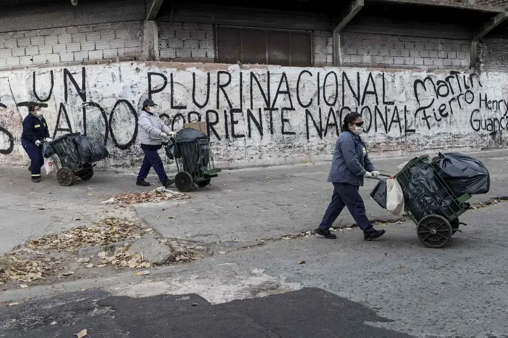 Members of FOL’s cleaning cooperative collect trash and disinfect the narrow corridors of the slum. Image by Anita Pouchard Serra. Argentina, 2020.